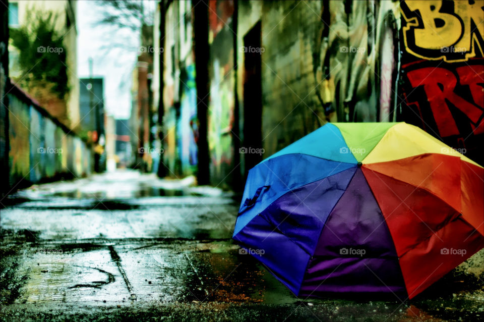 Colorful umbrella in the alley after rain