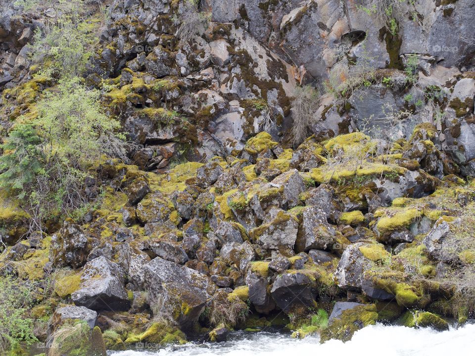 Rough and jagged rock walls form the canyon at Dillon Falls on the Deschutes River in Central Oregon. 