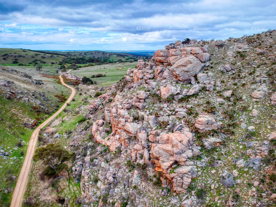 The Gap. A dirt road between two rocky hills. 