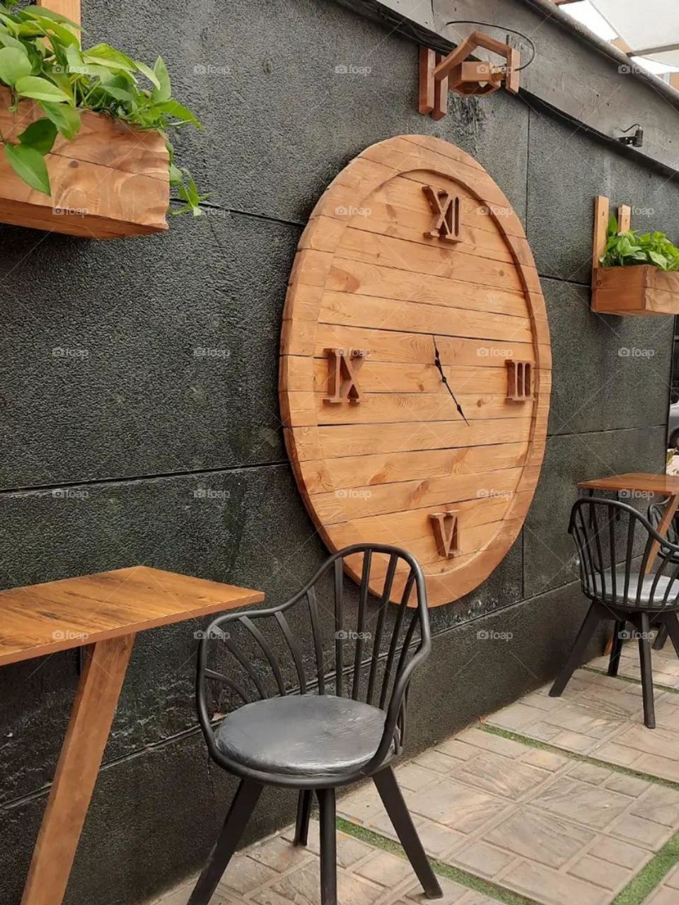 The combination of wood, black furniture and plants make this cafe a unic one, besides of all delicious cafees and desserts