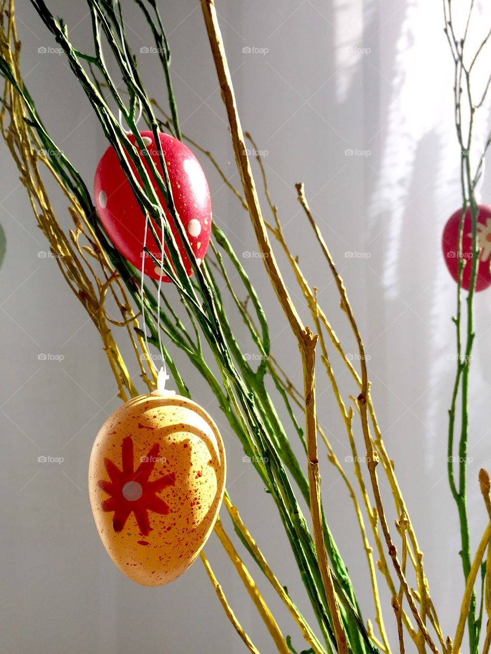 Easter eggs as decoration on stems at home 