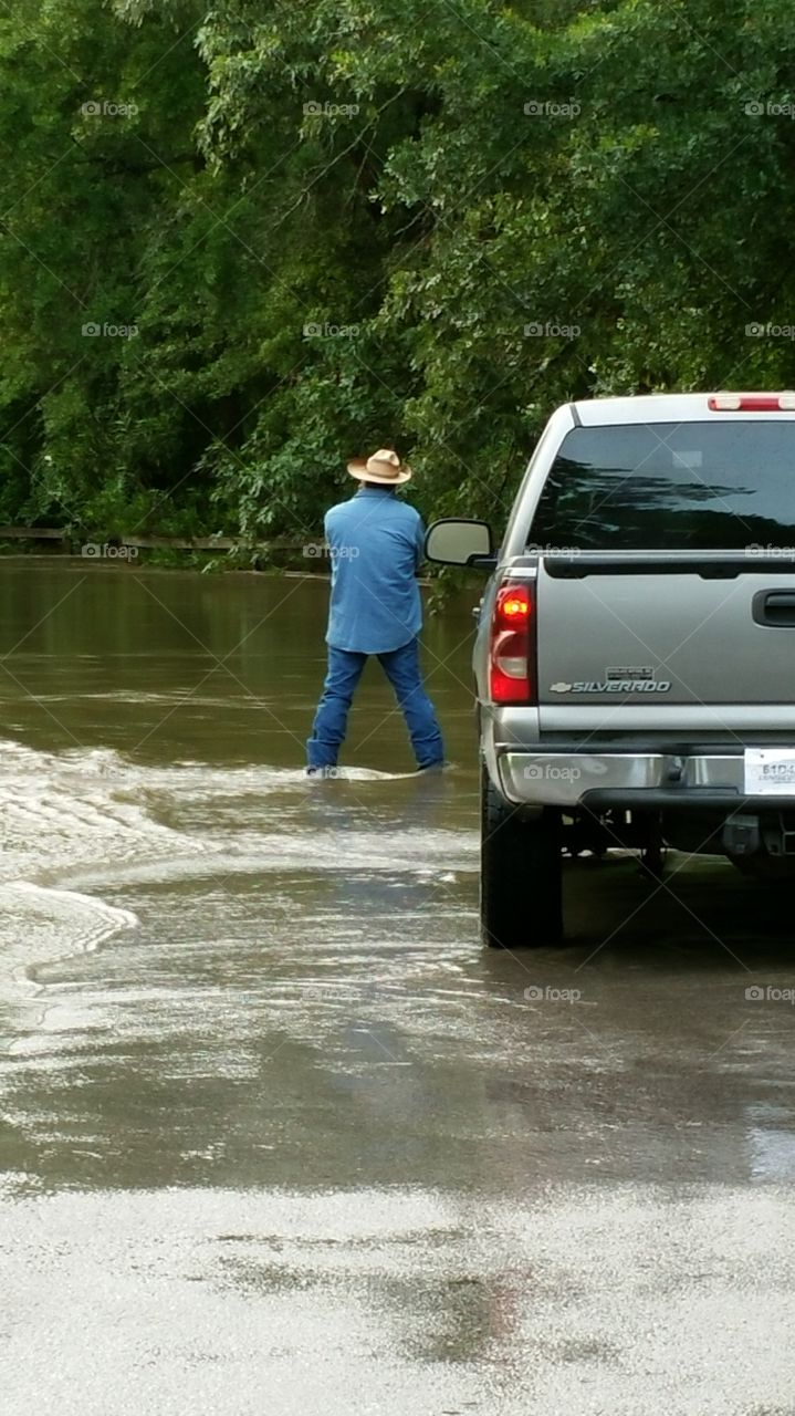 man observing flooding waters