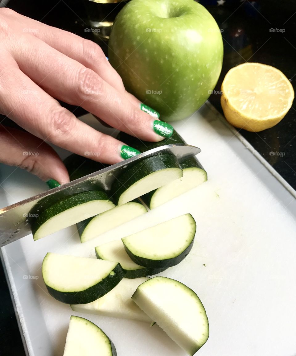 Hands Chopping Zucchinj