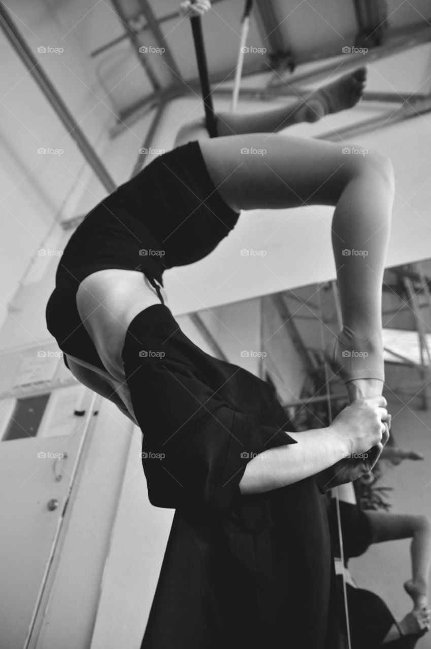 Trapeze artist showing flexibility during performance routine