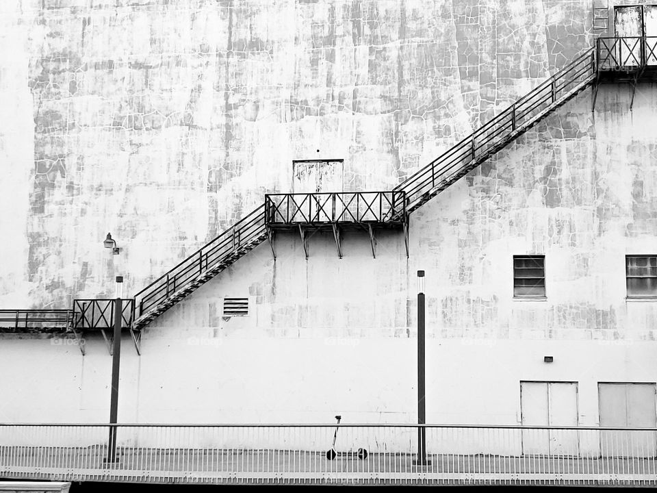 Architecture in black and white. Multiple stories exterior stairs.