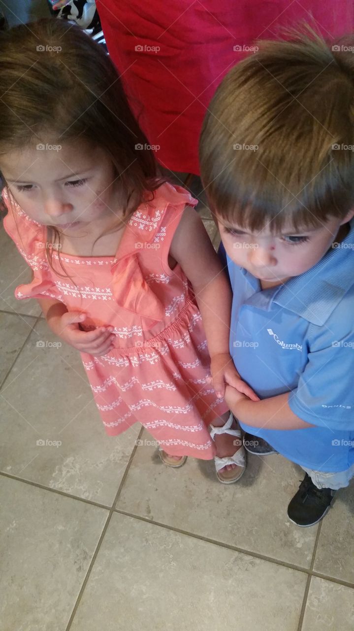holding hands. cousins who missed each other