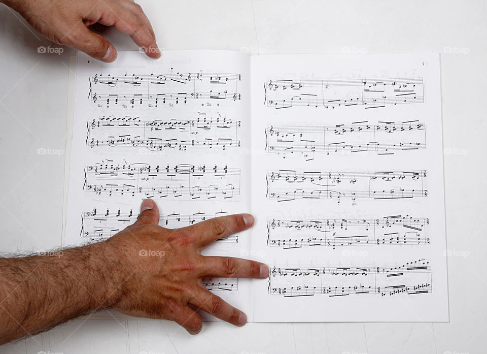 Man’s hands and musical notes 