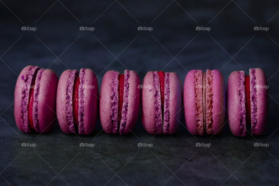 macaroons in a row on a dark background