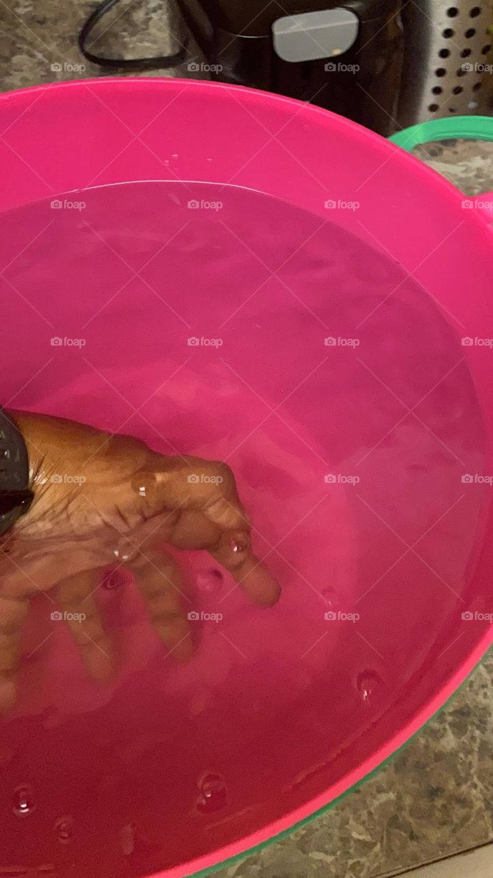 Hand pink bucket of orbeez and water 