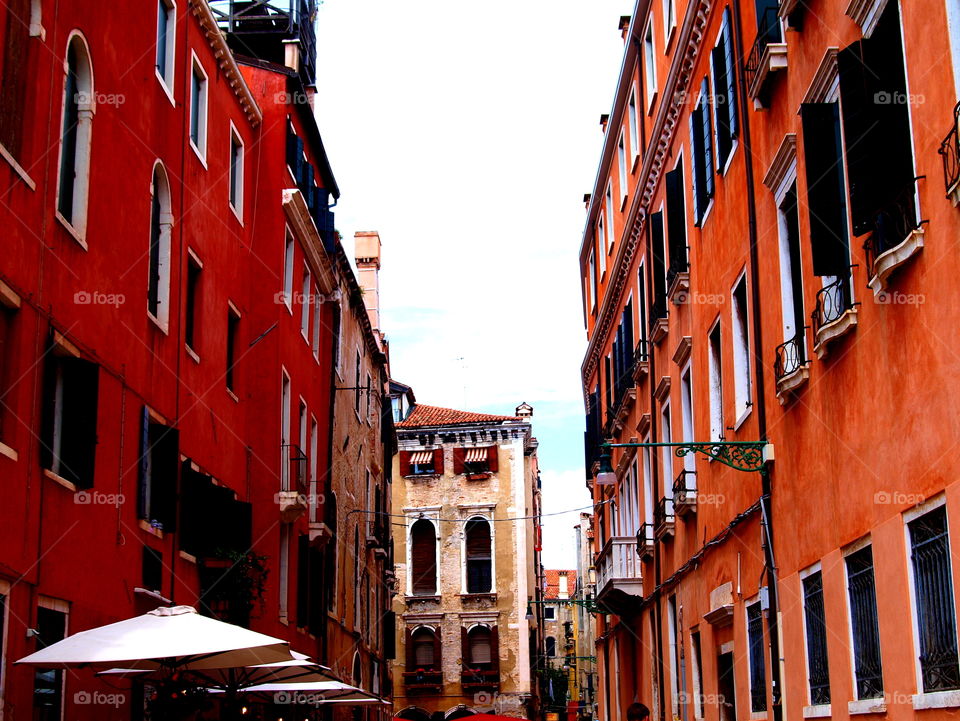 Street between red houses in Venice, Italy