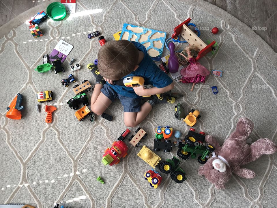 Boy playing with toys in his room 