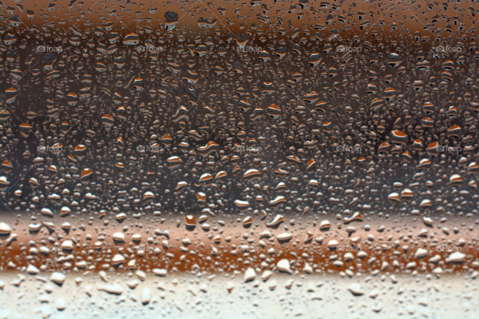 Raindrops on the window. Blurred photos background.