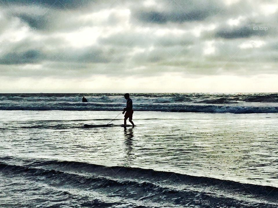 Boy at Beach. Overcast, persistent marine layer this day at Mission Beach. San Diego, CA