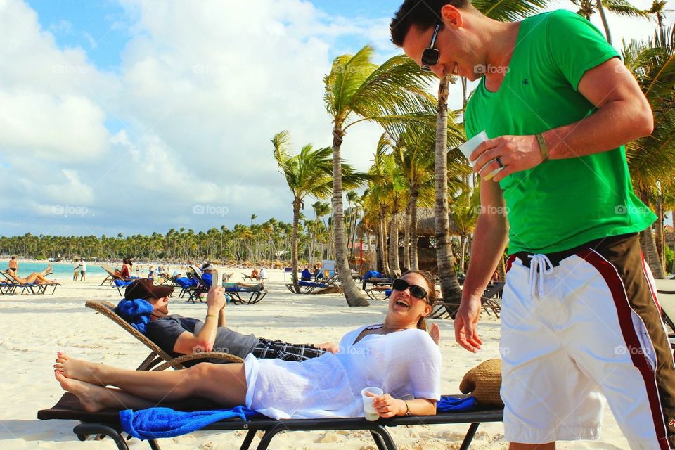 People on vacation on the beach talking and smiling 