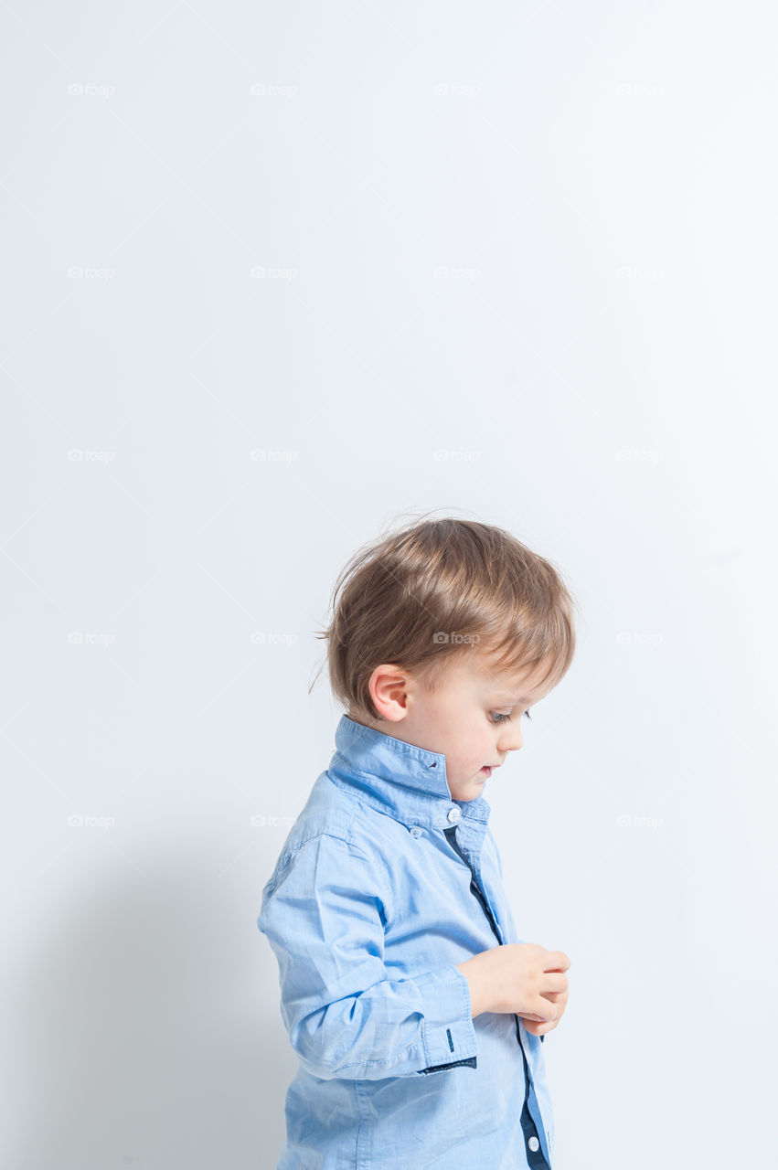 Little boy wearing a blue shirt.