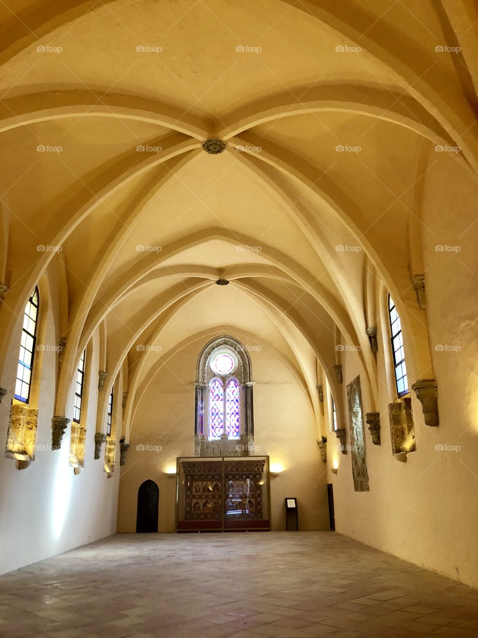 The beautiful arched yellow vaulted ceiling of a monastery long since retired. The room was once the dining hall for the monks. 