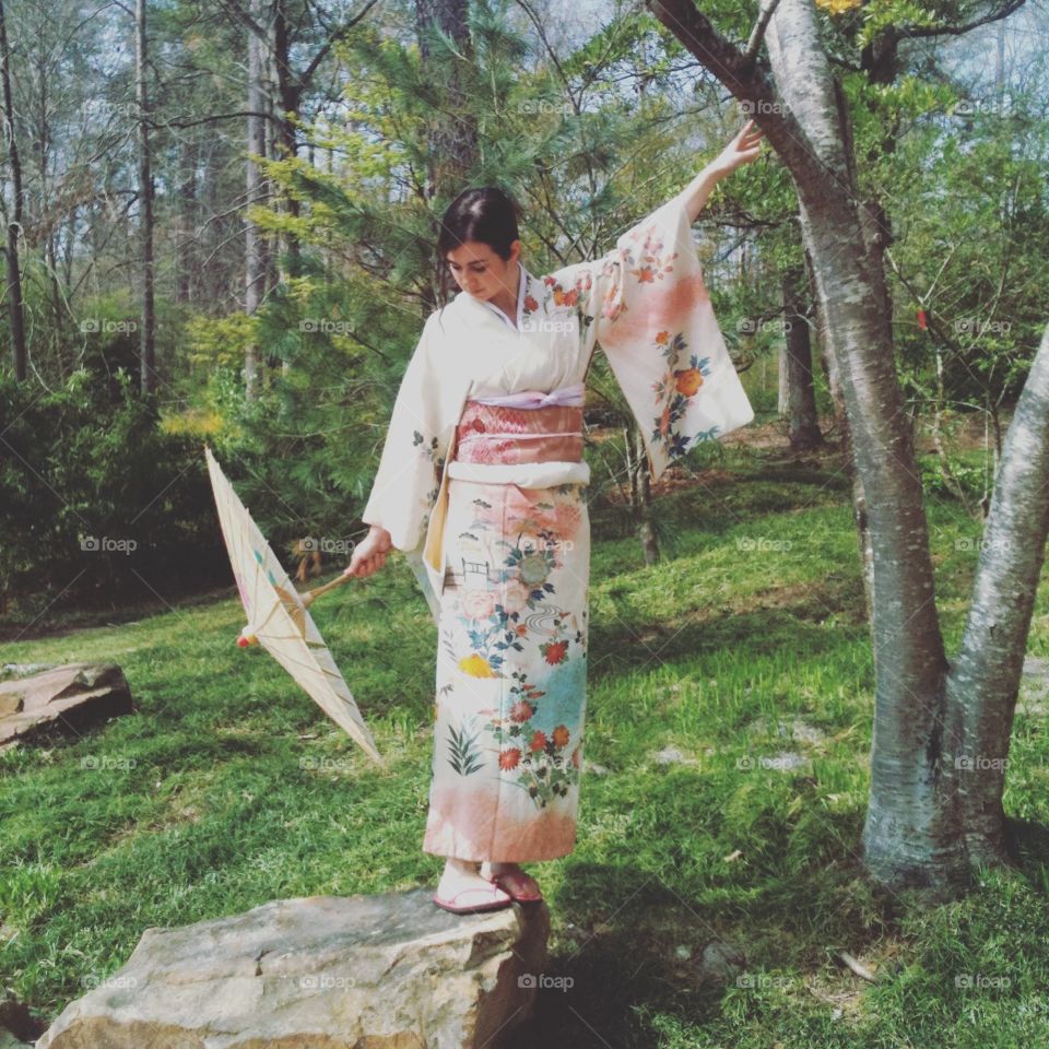 Girl with parasol and kimono at Japanese botanical gardens