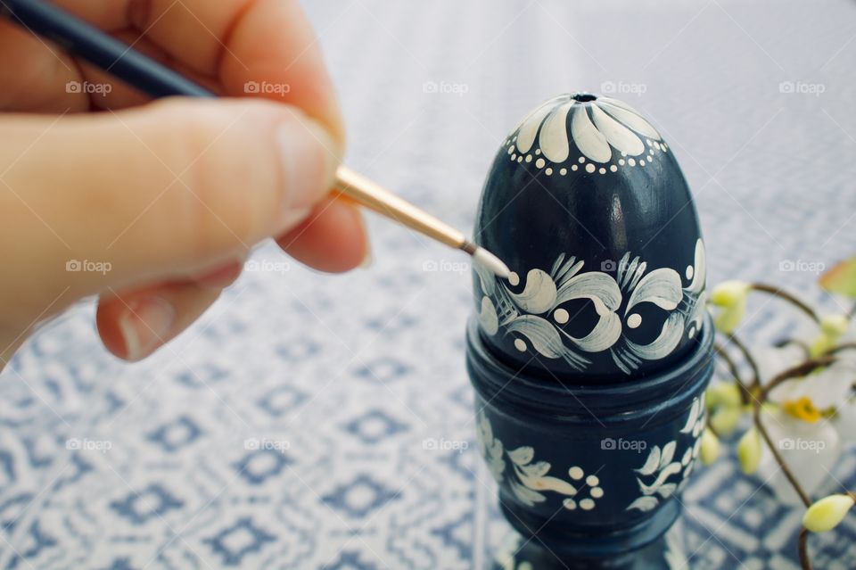 Painting an egg for Easter 