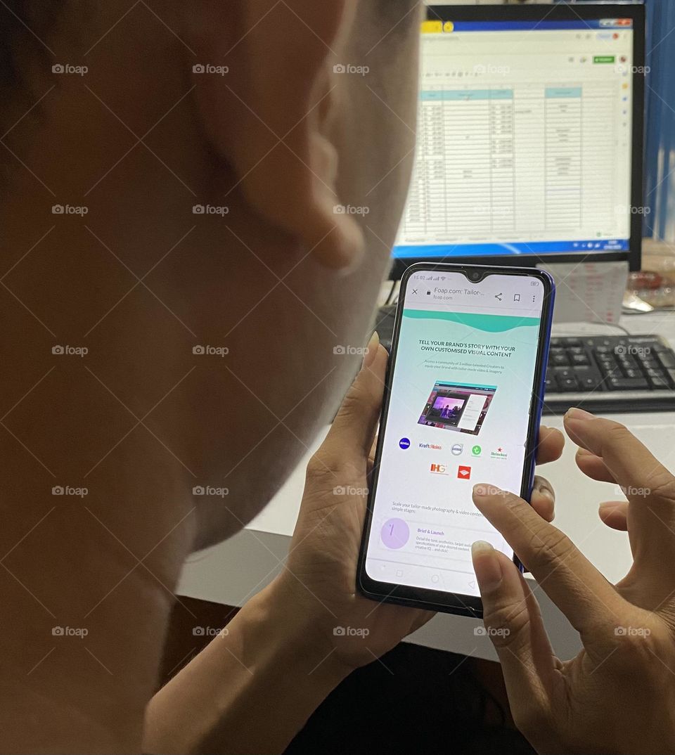 A man is opening the Foap app on smartphone
