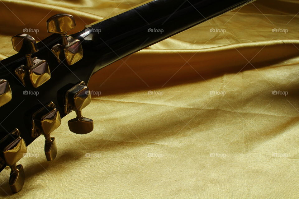 acoustic guitar on Golden textile