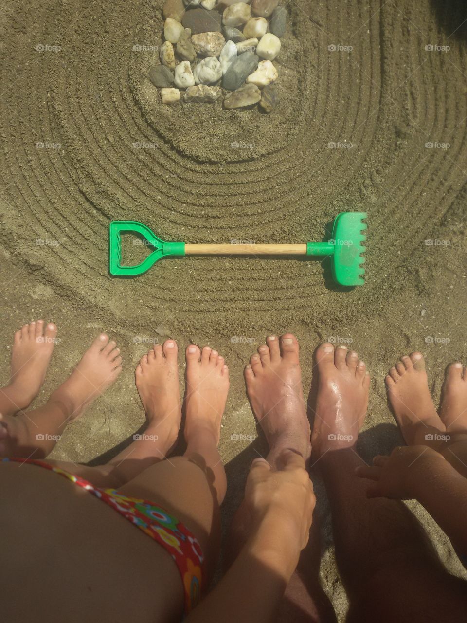 People's foot and toes on sand