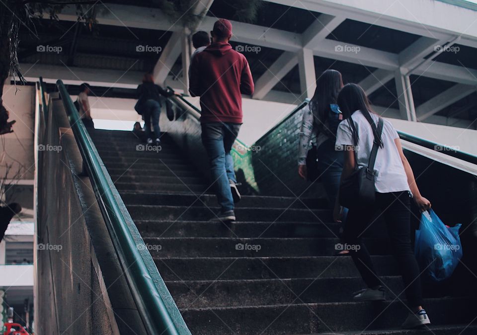 People walking up the stairs.