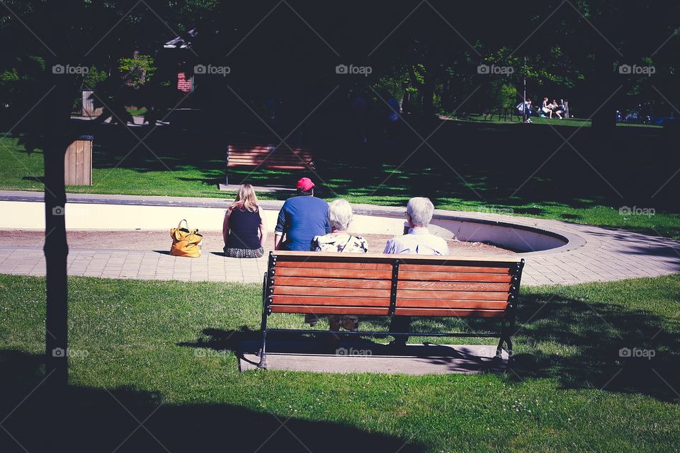 Elderly couple from behind.  A contrast between a young couple and an elderly couple.  Both still in love
