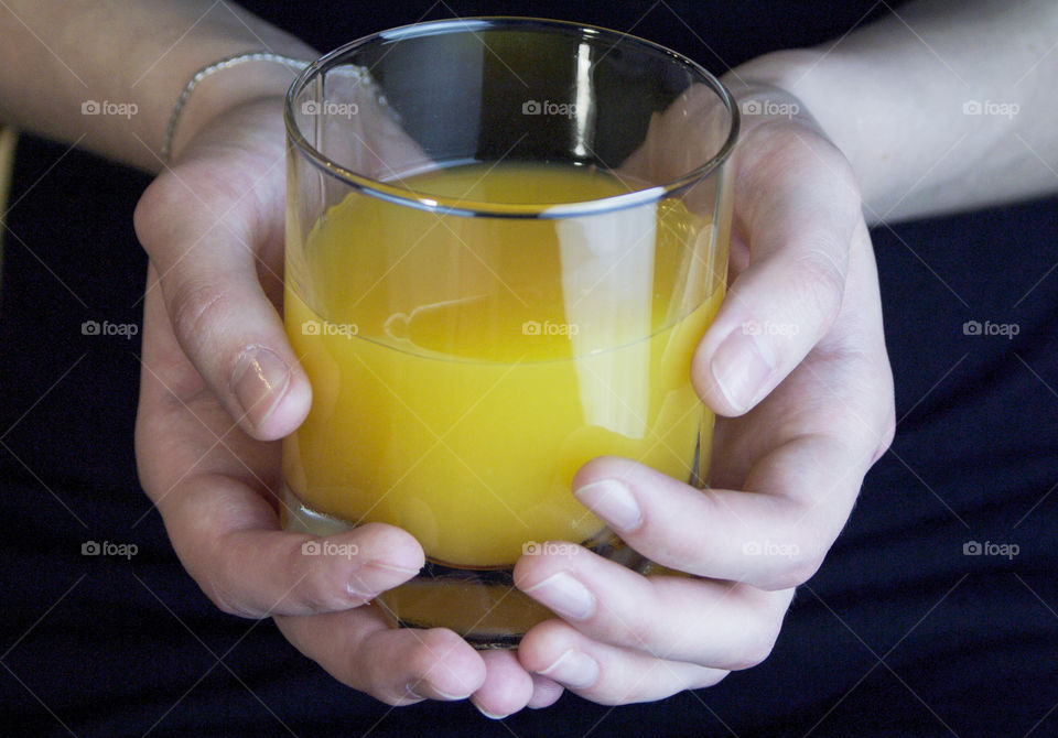 Juice and fruit in the hands of a girl