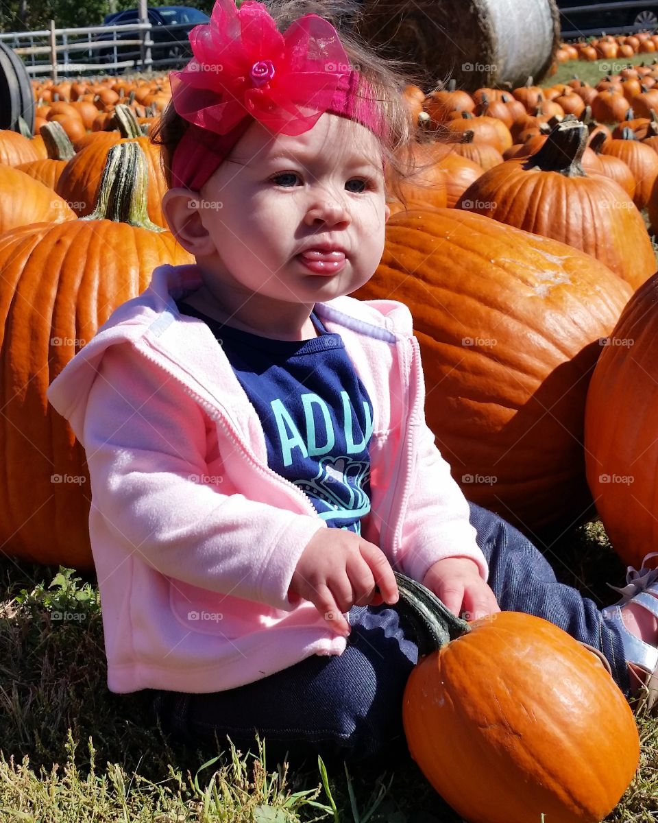 Girl sitting with pumpkins