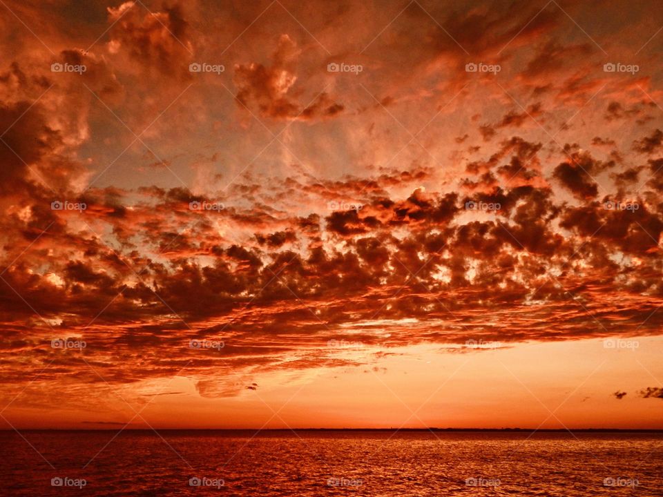 Clouds - Massive red clouds over the Gulf of Mexico lit by the descending sunset
