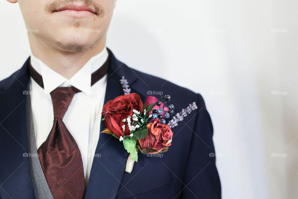 Groom upper body jacket tie mouth and boutonnière purple  
