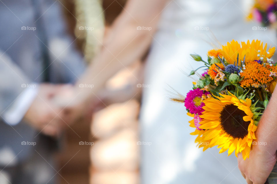 A bridesmaid holds a bouquet