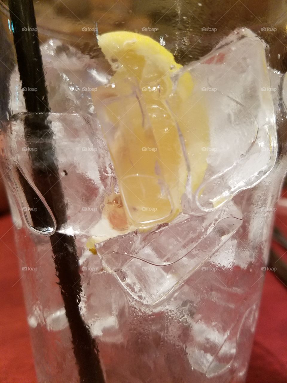 water glass with lemon and extra ice