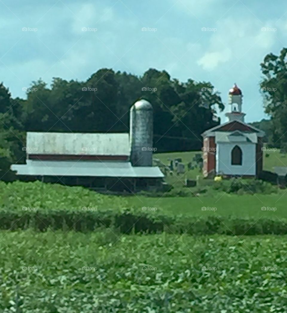 Amish Barn and Church in the Pennsylvania countryside  in summer.