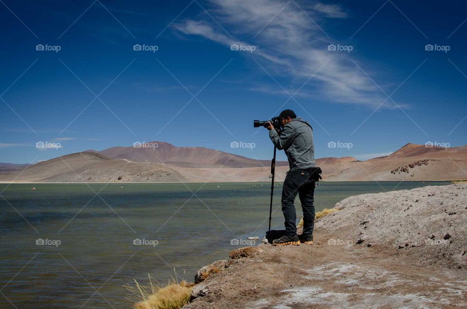 man taking pictures in nature