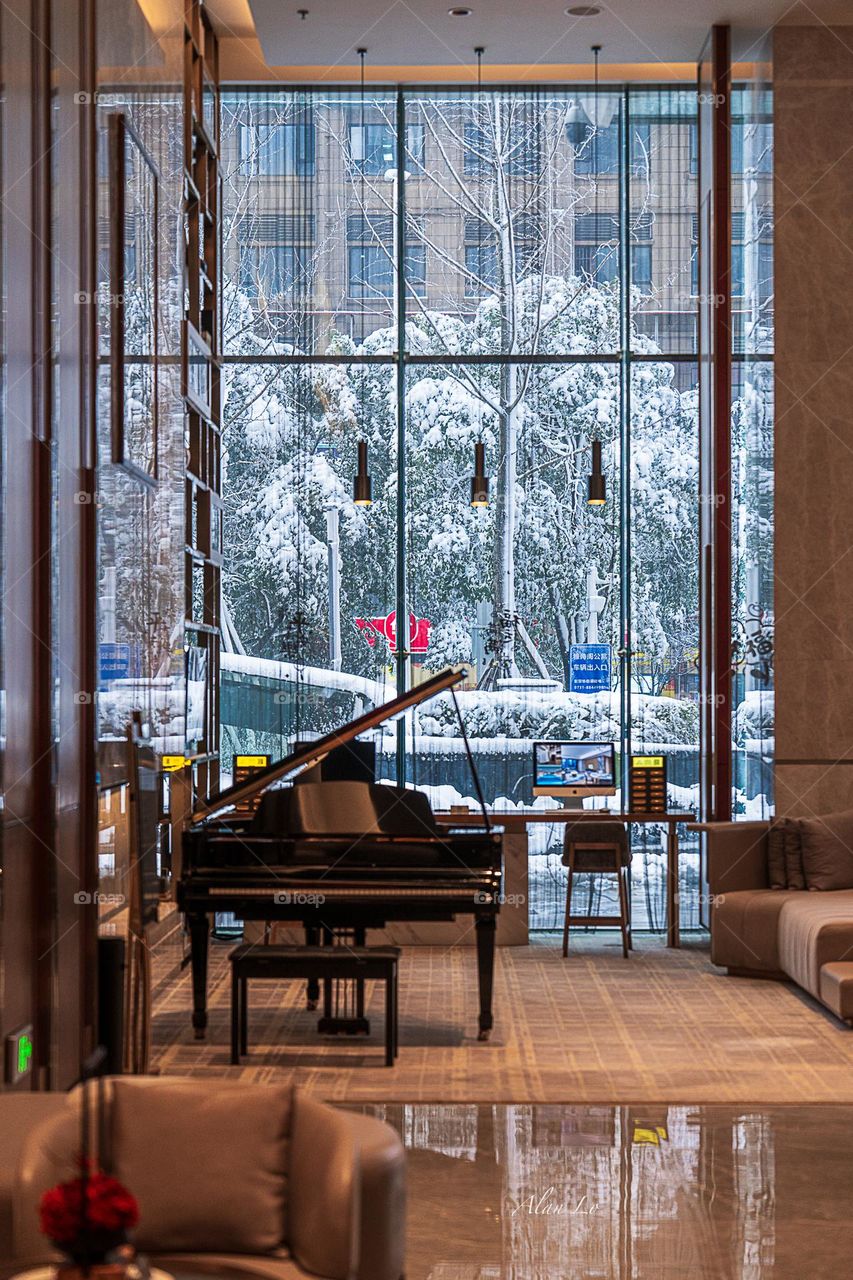 Cozy hotel lobby with heavy snow outside