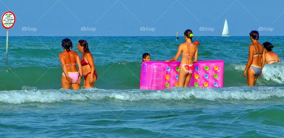 group of people bathing in the sea. summer. holidays. outdoor. sun.