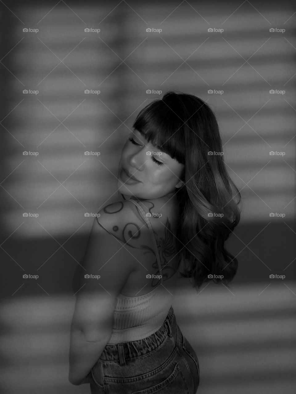 beautiful girl in the shadow of the window.