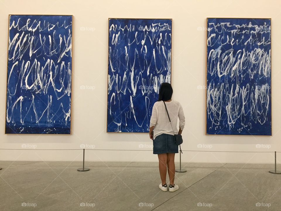Woman looking at artwork in a museum