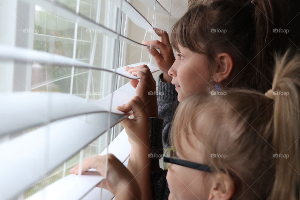 Two girls looking out the window