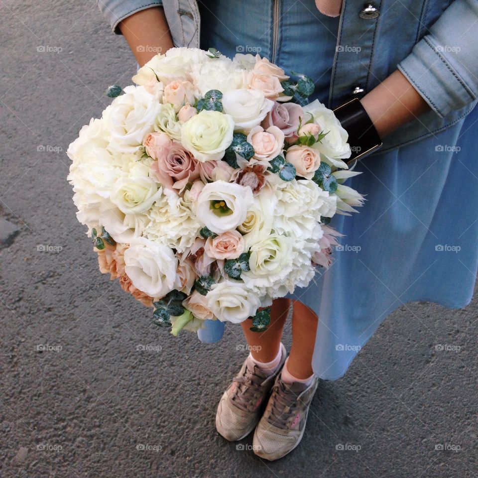 Florist  hands and wedding bouquet for the bride