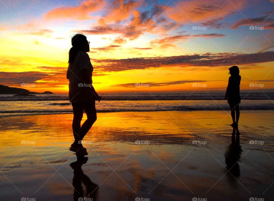 Silhouette of two girls at beach