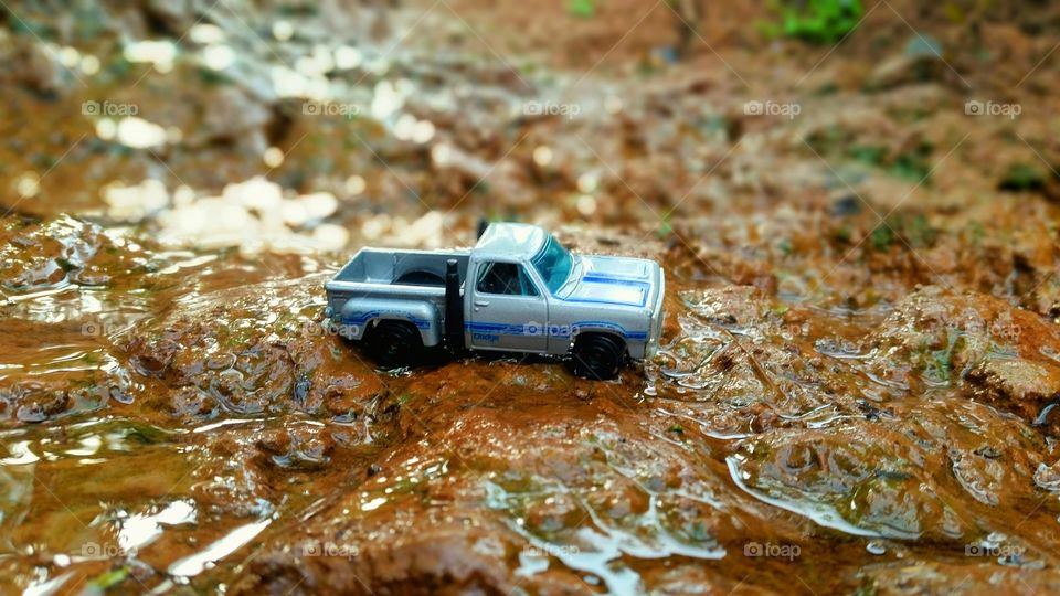 miniature truck cars that are crossing the river