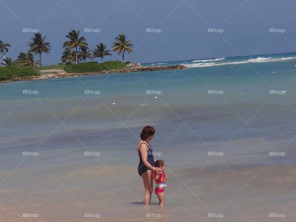Grandma and Me. Grandmother and child playing in the ocean