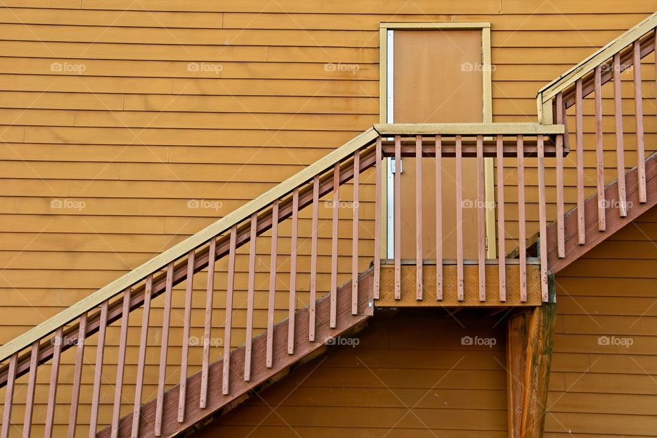 Minimalist yellow building door and stairs