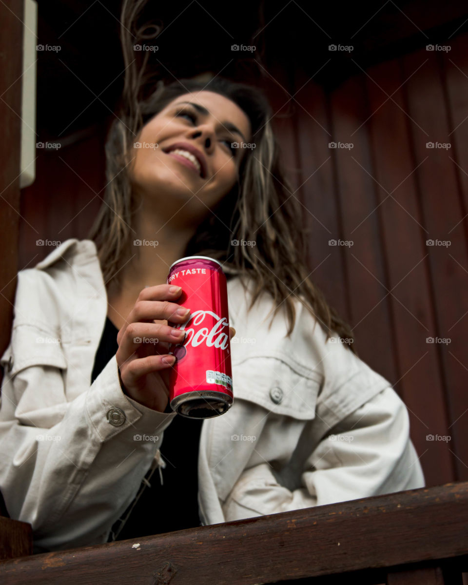 Showing off some coca cola with a big smile.
