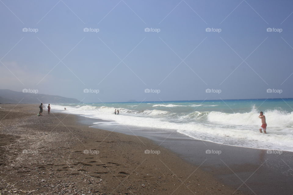High waves on a sandy beach on Rhodes island, Greece