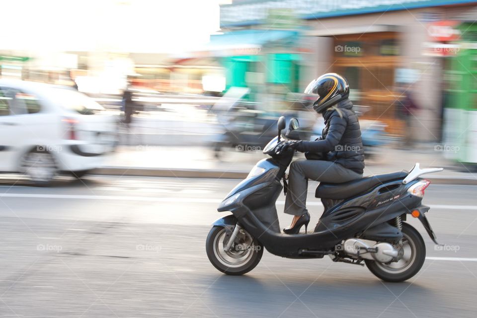 Woman on scooter.