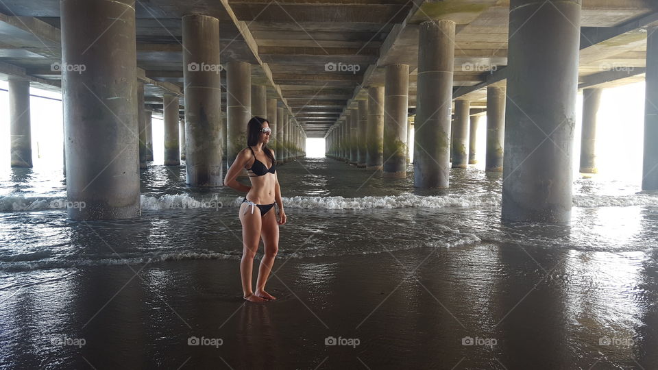 Woman in bikini standing in sea