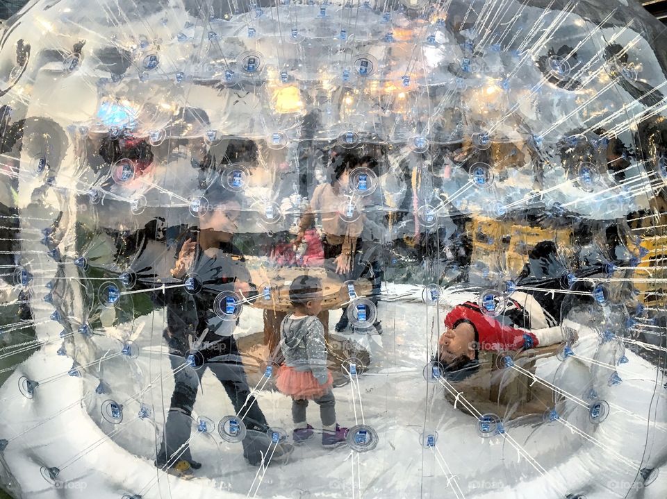 Having fun in the zorb. Folks in Taipei, Taiwan are out celebrating beautiful Saturday evening in the Xinyi district.